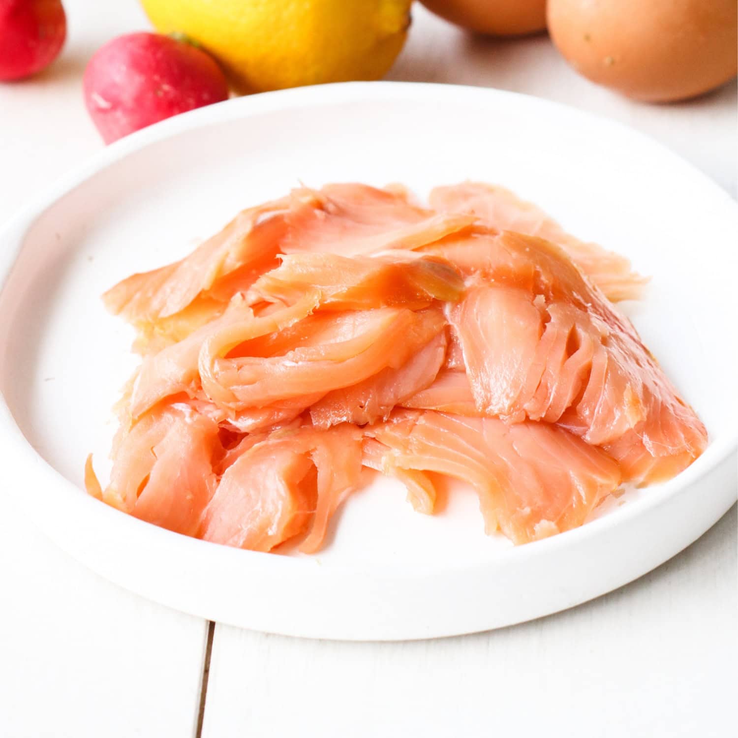 freshly sliced salmon on a white plate