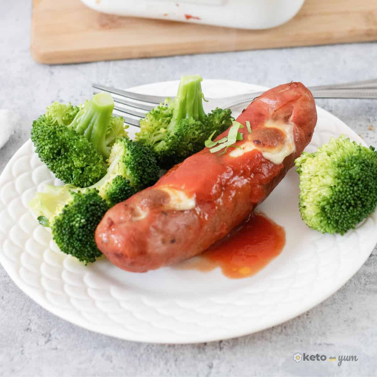 mozzarella stuffed sausage with marinara sauce served with broccoli